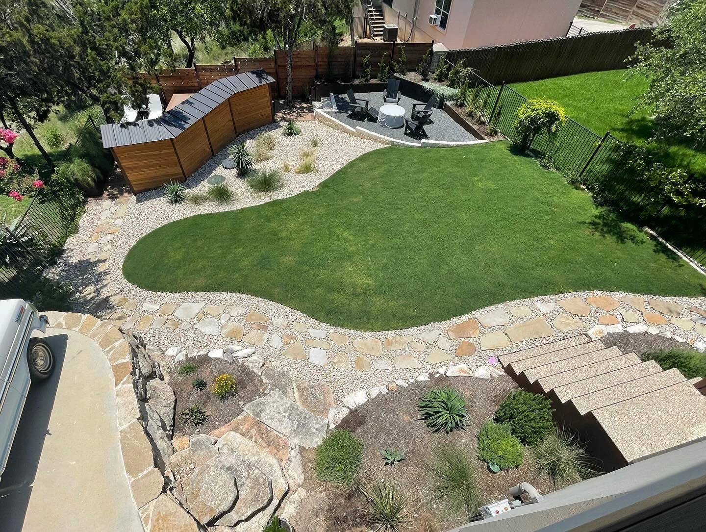 Overview of a Solstice landscape with lawn, planted borders and stone paths